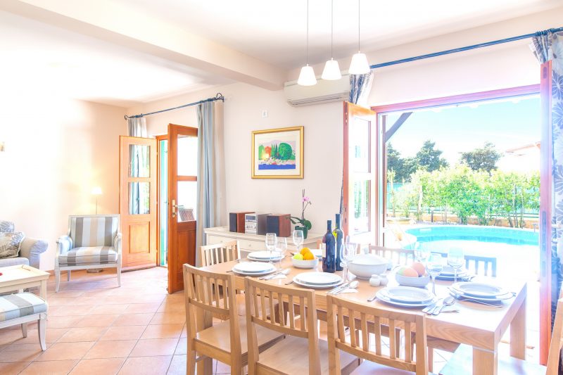 Dining room in Villa Cvita with opened French doors and exit to the swimming pool