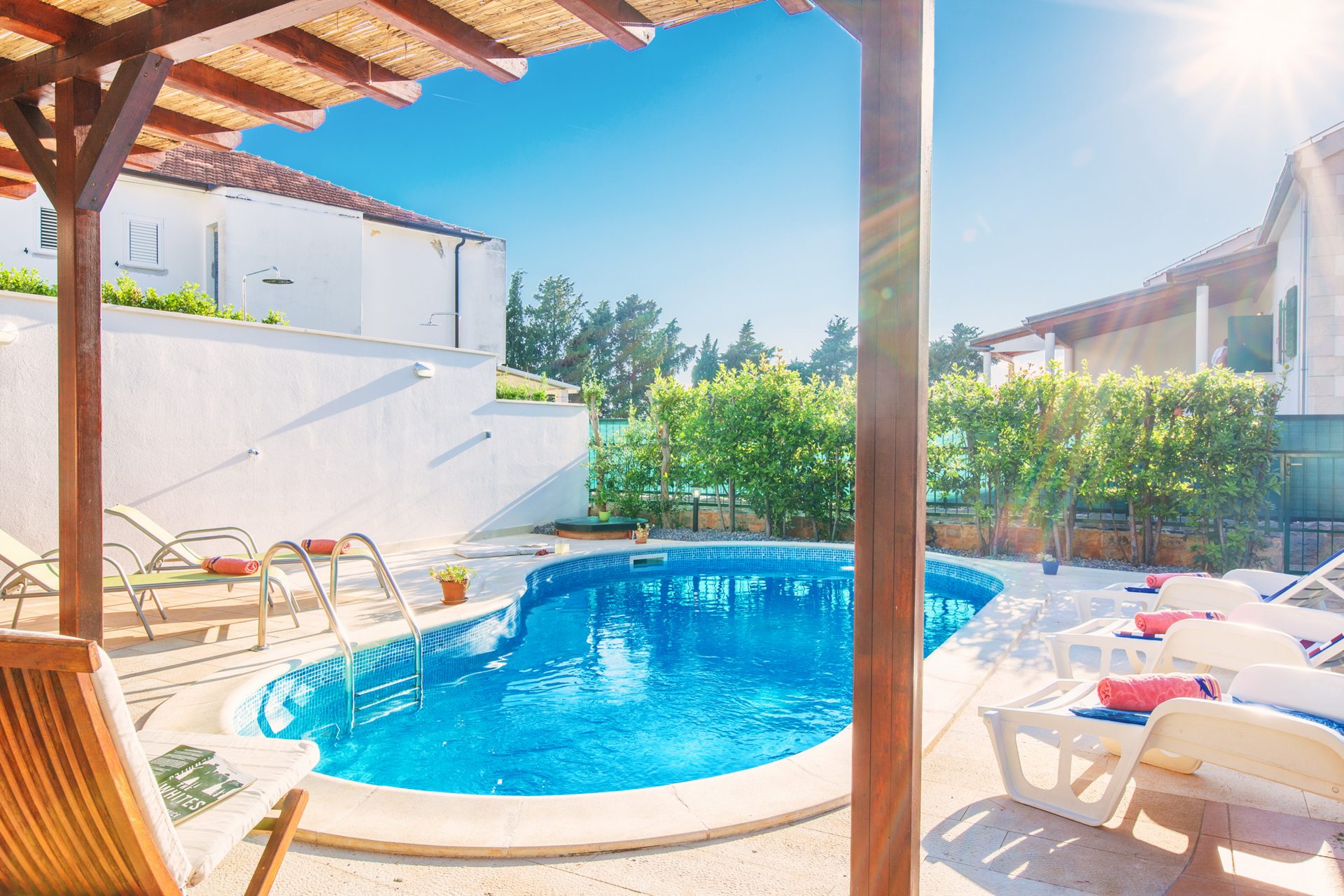 Private swimming pool with bed chairs in Villa Cvita